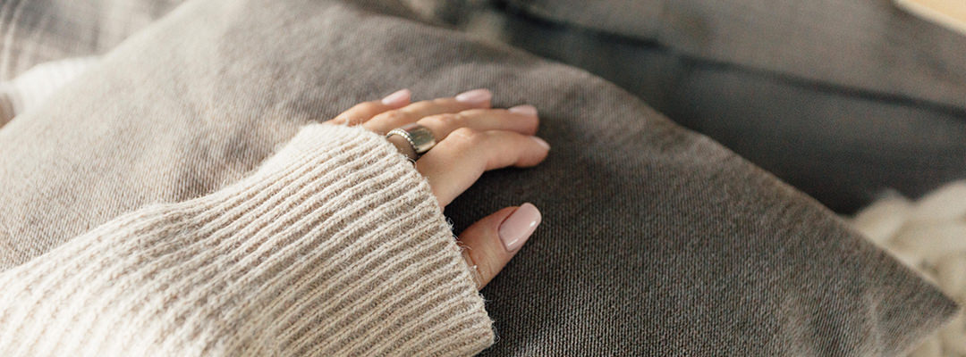A woman hand touching a pillow