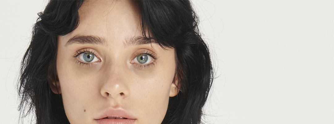A woman with dark circles under her eyes