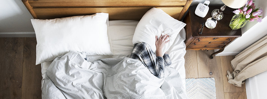 A person having trouble sleeping because of the noise