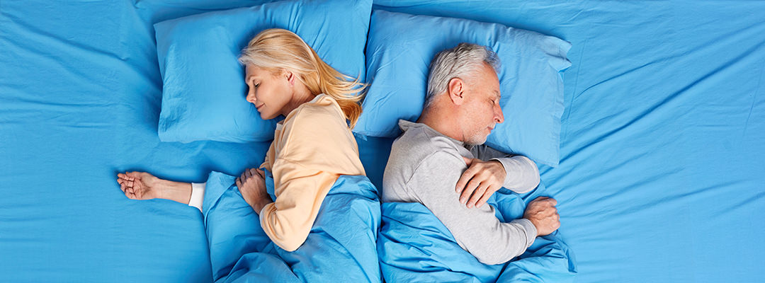 Elder people sleeping in their bed