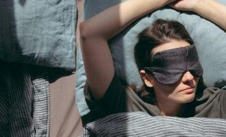 A woman sleeping with a mask on her eyes